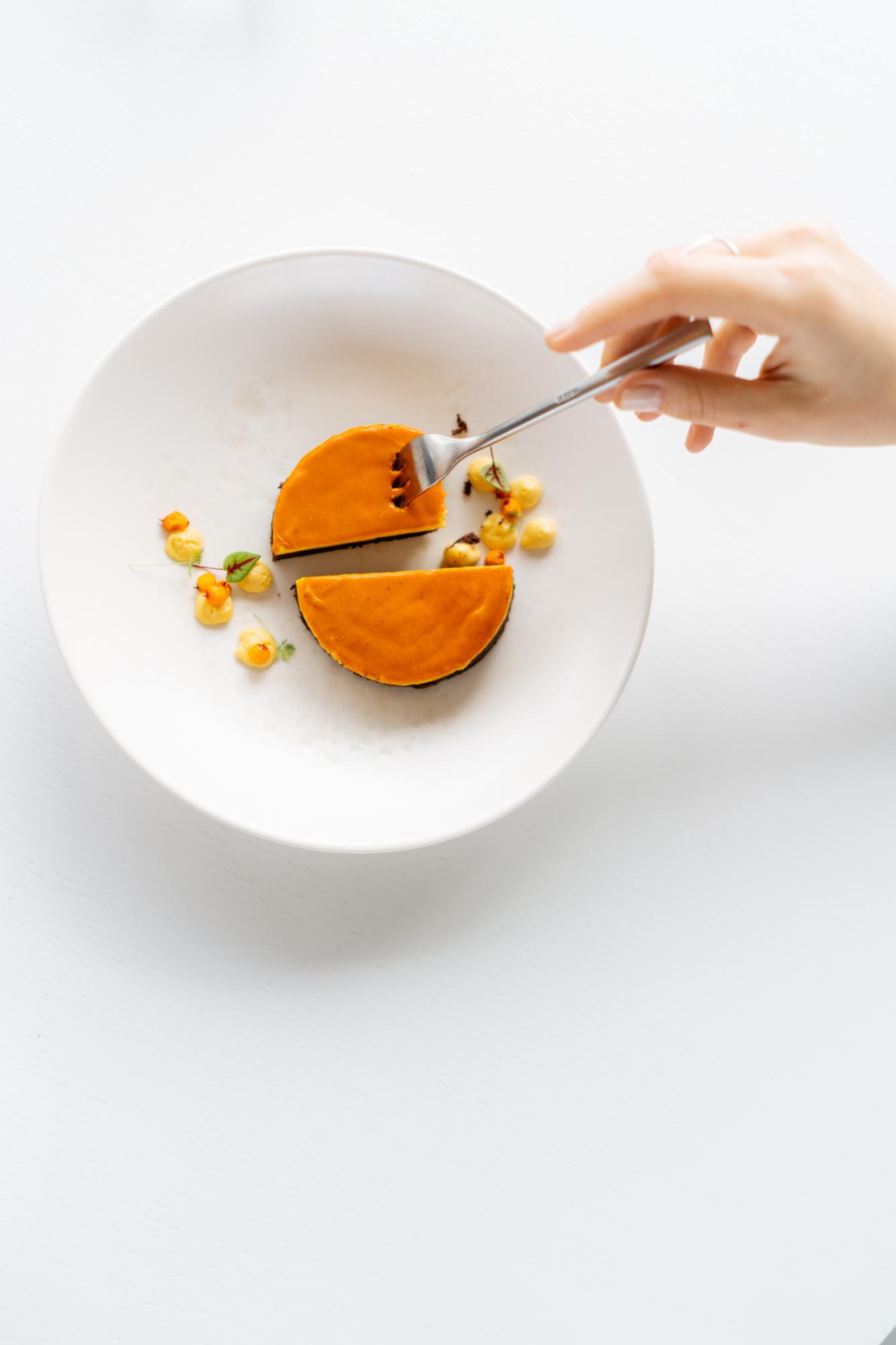 Chef plating a modern dish in a bright kitchen